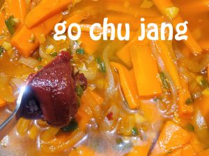 adding go chu jang sauce
